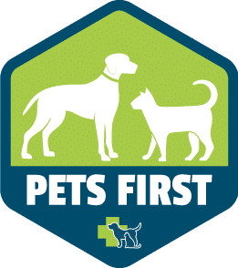 Logo badge featuring a white dog and cat on a green and blue background with the words “PETS FIRST” in bold white letters and the Dr. Kelly’s Surgical Unit logo beneath.